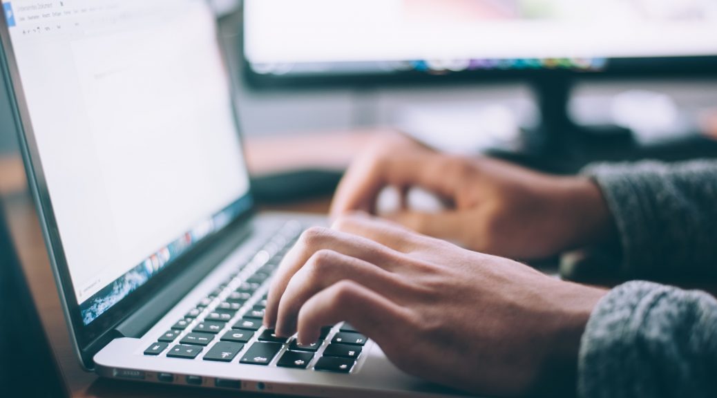 Man typing at keyboard