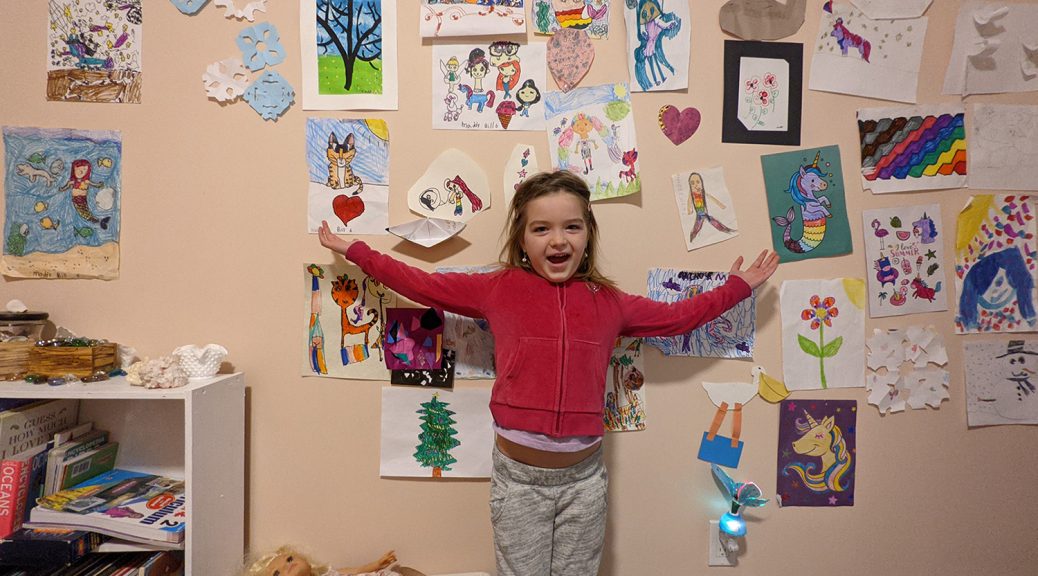 Maddy with her art wall